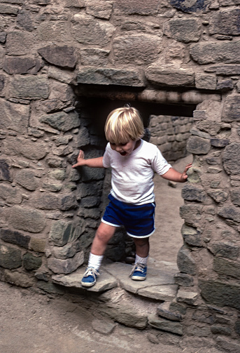Aztec Ruins NM - Small Boy in Doorway  - 1990. Scanned from Kodachrome 64 slide.