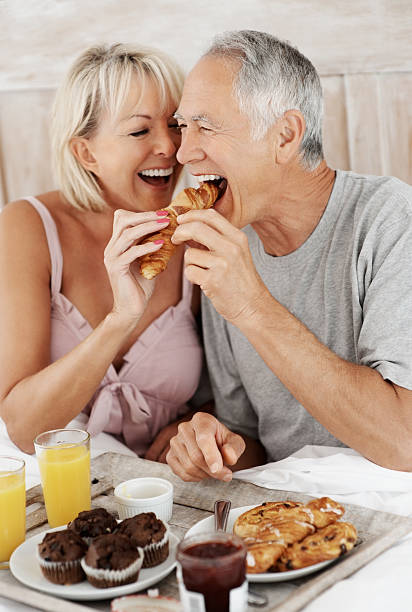 istock Romantic mature couple enjoying their breakfast in bed 182905434