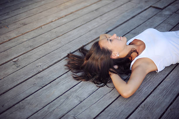 Beautiful girl resting on a wooden pier
