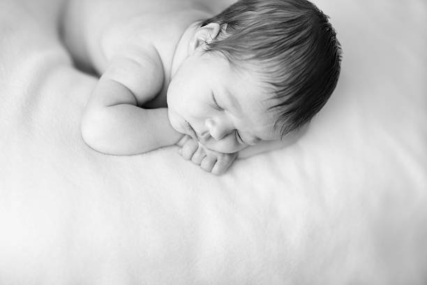 istock Newborn Baby Sleeping Peacefully on Soft Blanket 182905553