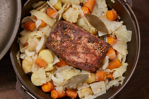 Preparing Slow Cooked  Corned Beef and Cabbage Brisket with Potatoes, Onions and Carrots