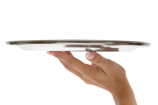 Female hand holding a silver tray. White background.