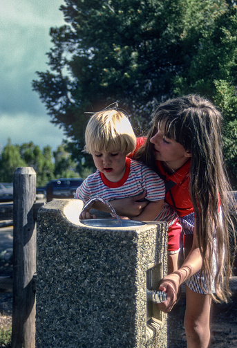 Mesa Verde NP - Girl Helps Young Brother at Drinking Fountain  - 1990. Scanned from Kodachrome 25 slide.