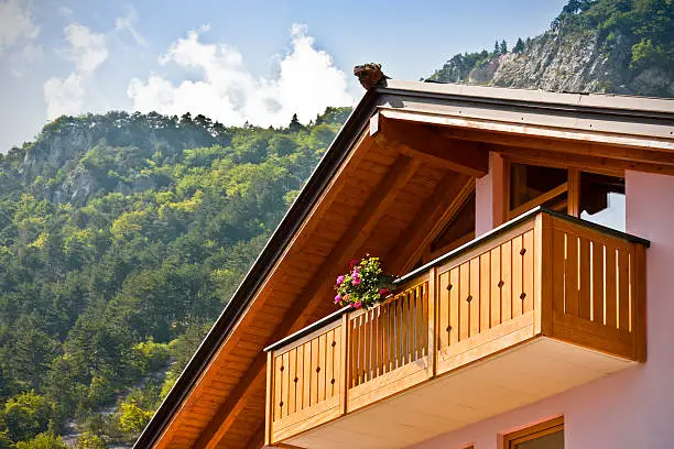 Wooden balcony on the Dolomites mountains. The location is the Dolomiti del Brenta (Trentino-Alto Adige, Italy) during the summer season.