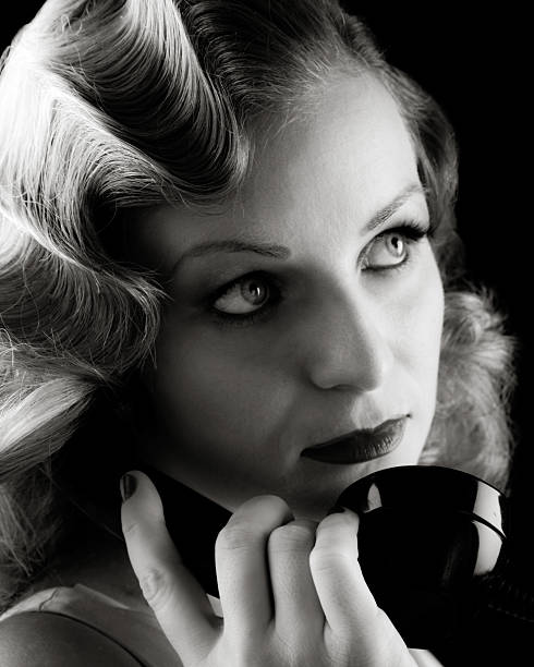 Retro Portrait of Woman on Old Telephone. Film-noir B&amp;W. stock photo