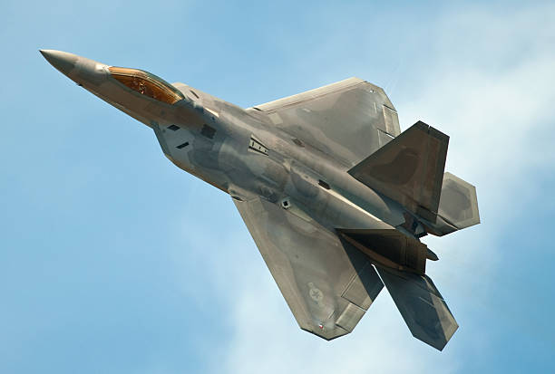 istock F22 Raptor jet flying in clear blue sky 182906228