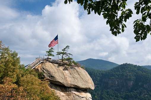 Top of Chimney Rock, North Carolina, with a waving American flag.