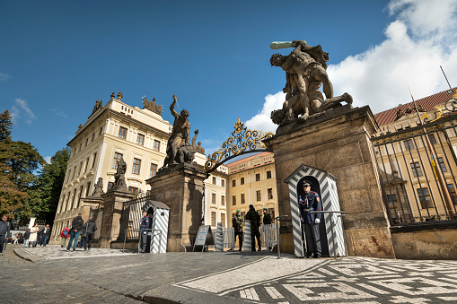 Prague, Czechia - September 18, 2022:  People gather in the courtyard by the guarded Matthias Gate entrance to the Prague Castle complex Czech Republic Czechia Europe