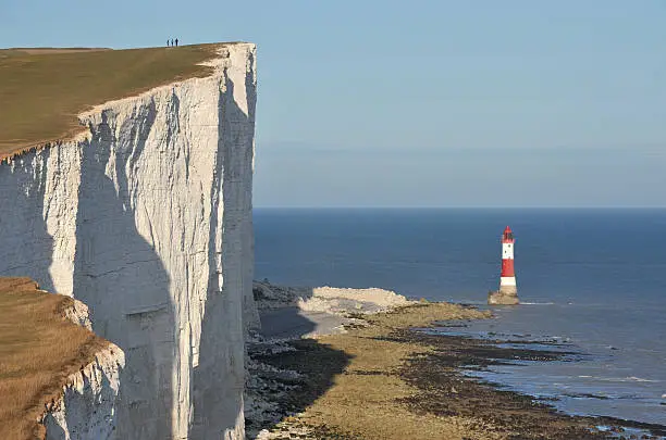 "Beachy Head chalk cliffs and lighthouse Beachy Head is a chalk headland on the south coast of England, close to the town of Eastbourne in the county of East Sussex, immediately east of the Seven Sisters. The cliff there is the highest chalk sea cliff in Britain, rising to 162 m (530 ft) above sea level. Its height has made it one of the most notorious suicide spots in the world"