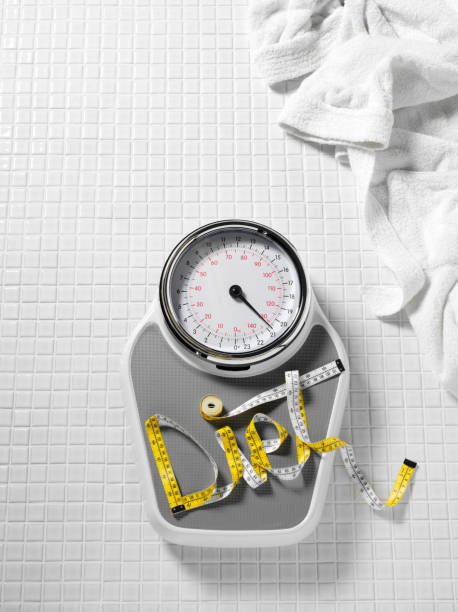 istock Diet and Tape Measure on Bathroom Scales 182906994