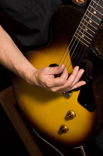 istock Arm and Hand Picking Electric Guitar 182907082