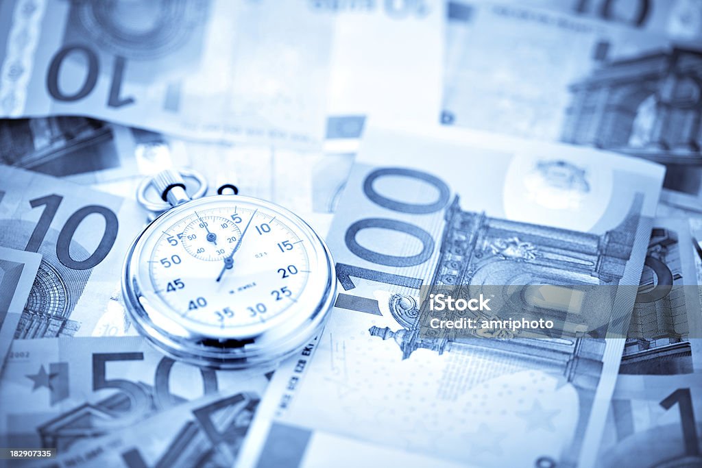 stopwatch on euros perspective wide stopwatch on pile of euro banknotes can be used for various concepts perspective Deadline Stock Photo