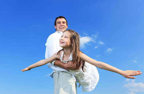 istock Father playing with daughter outside. 182907347