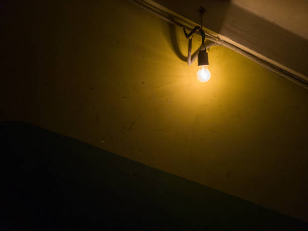 istock Tungsten bulb in old dark basement on the wall. 1829074799