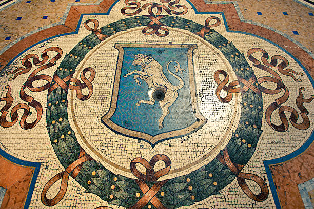 Turin Bull Crest in Milan Galleria Vittorio Emanuele II "A stock photo of the mosaic tile crest of the city of Turin on the Milan Gallery floor in Italy. The tile floor was was designed and layed with the structure in 1861 during the period of the unification across Italy, each crest representing a major city." galleria vittorio emanuele ii stock pictures, royalty-free photos & images