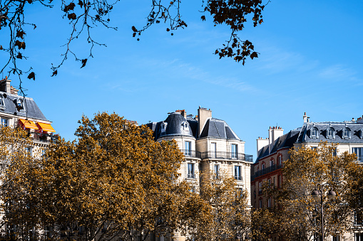 Facade of a Parisian building in autumn, in France.