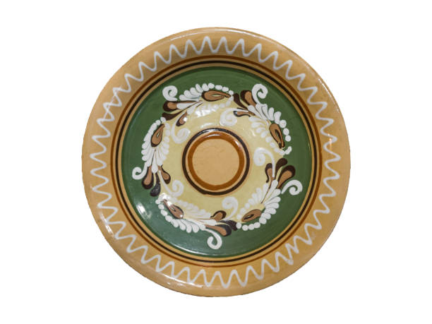 istock Traditional authentical Ukrainian glazed clay plate with an ornament, top view, isolated on white background. 1829080076