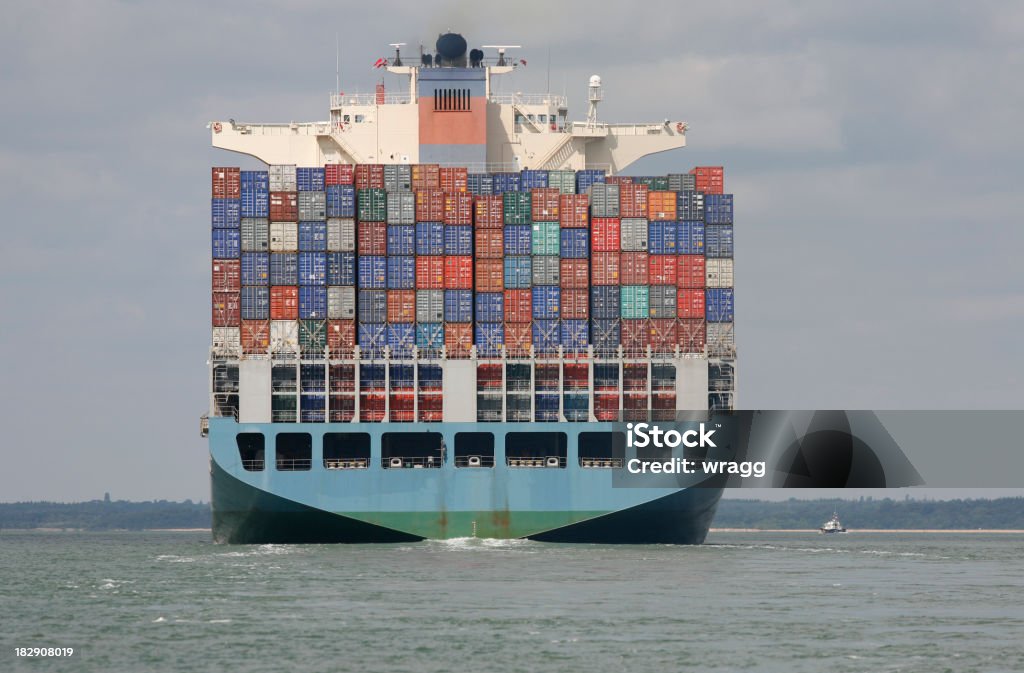 Global Trade on a Container Ship Container ship heading to seaClick on the link below to see more of my shipping images. Business Stock Photo