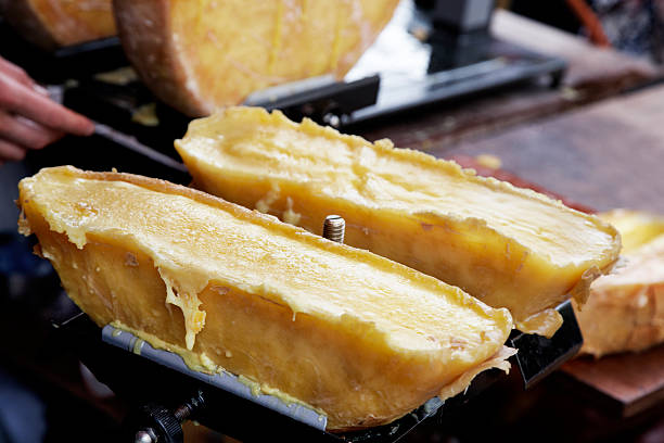Raclette cheese stall at market. Traditionally heated until the top has melted then scraped over potatoes. 