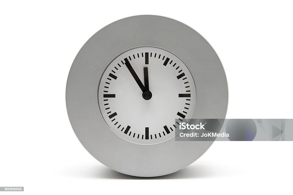 Gray Clock "Simple clock, showing five minutes to midnight. White background." Wasting Time Stock Photo