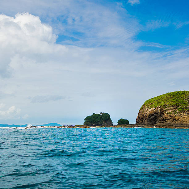 costa rica islets islets at playa hermosa region in costa rica - province of guanacaste costa rican sunset stock pictures, royalty-free photos & images