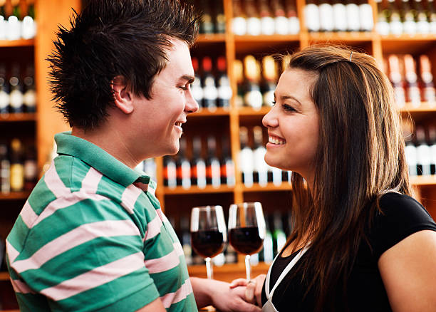 istock Young couple smile at each other in bar 182908918