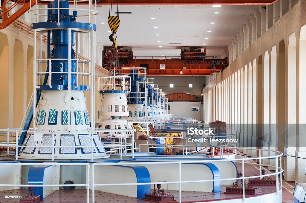 Hydro-electric Power Generators Row of the tops of indoor hydro-power generators working at a dam.  The huge turbines in these generators turn as the water blasts through, creating electricity. Hydroelectric Power Stock Photo