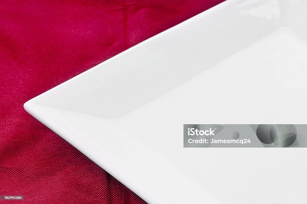 Square Plate and Red Tablecloth The corner of a clean blank square plate on a red tablecloth. Add your own food! Blank Stock Photo