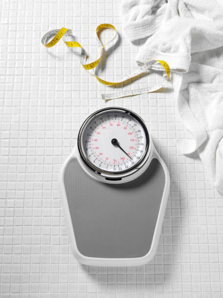 istock Bathroom Weighing Scales on White Tiles 182910481