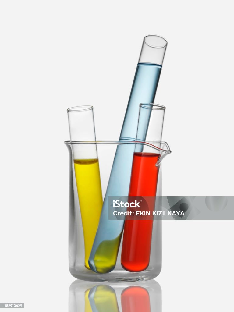 Close-up of test tubes inside a beaker laboratory flasks isolated on white background. Test Tube Stock Photo