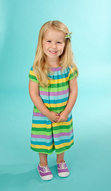 istock Adorable Little Girl Smiling on a Blue Background 182910670