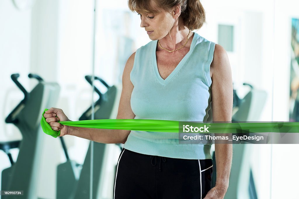 Rotator Cuff Exercises Woman doing internal and external rotator cuff exercises using a thera-band. This exercise is done to help recover from rotator cuff injuries. Horizontal shot. Rotator Cuff Stock Photo