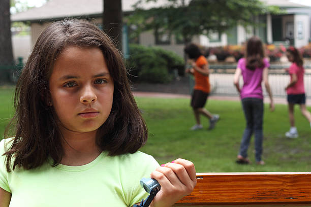 Thirteen-year-old girl climbs the bars at her neighbourhood park.