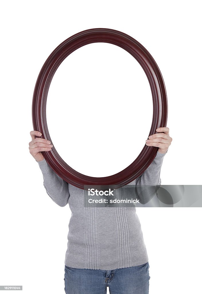 Woman Holding Blank Frame A woman holding a blank oval frame over her face. Mirror - Object Stock Photo