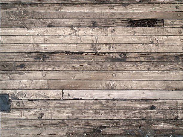 Old wooden floor of the sailing boat, with scratches, cracks stock photo