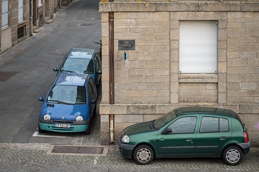 Saint-Malo, France – October 11, 2023: Two nice Renault Twingos parked facing each other in one corner and in the other I saw a second generation Renault Clio
