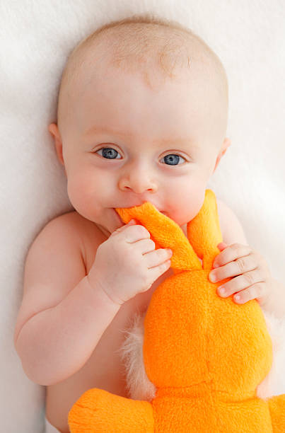 Happy baby playing with a toy