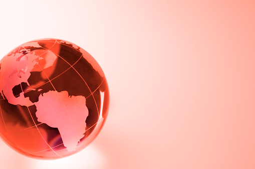 Red glass globe of world. Concept for global warming.