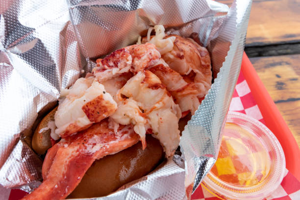 Freshly served delectable and iconic New England style clam cakes with fries and lobster roll with butter.  Casual dining in Maine.