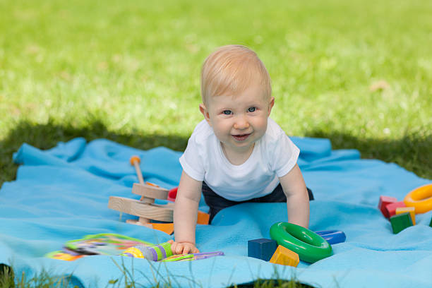 istock baby girl on blue blanket 182912550