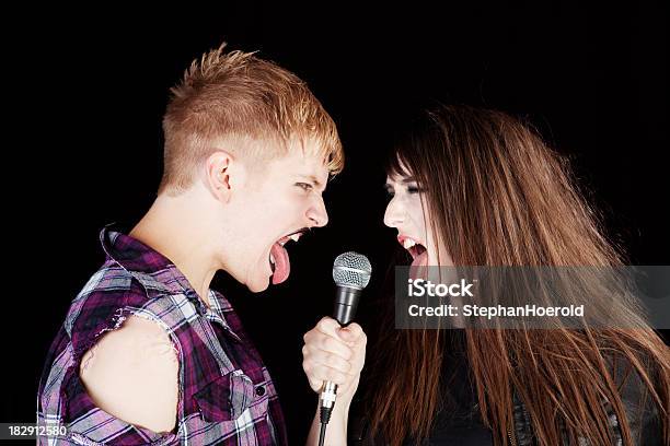 Young Couple Sticking Out Tongues Punk Rocker Style Stock Photo - Download Image Now