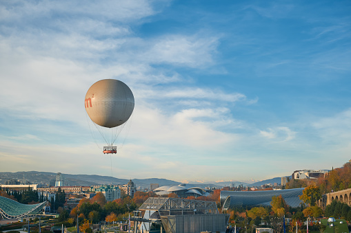 blimp flying in clear blue sky with blue copy space to advertise your message