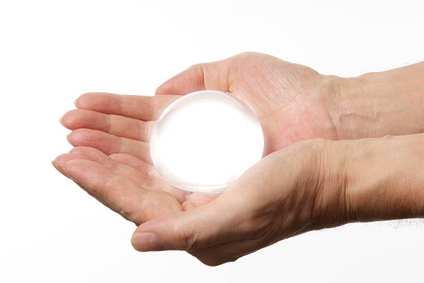 istock Holding a shine glass ball against white background 182912818