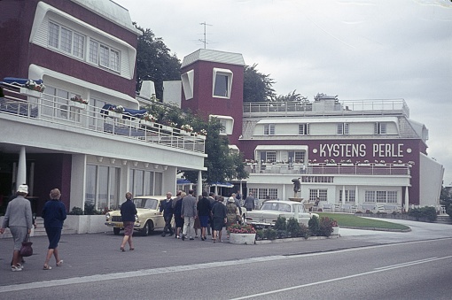Near Copenhagen, Zealand, Denmark, 1964. Street scene with a tour group in front of a restaurant near Copenhagen.