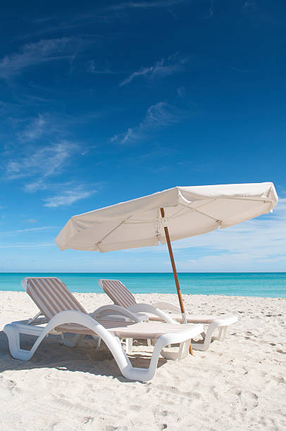 istock Beach Umbrella Two Lounge Chairs and Blue Sky 182913533
