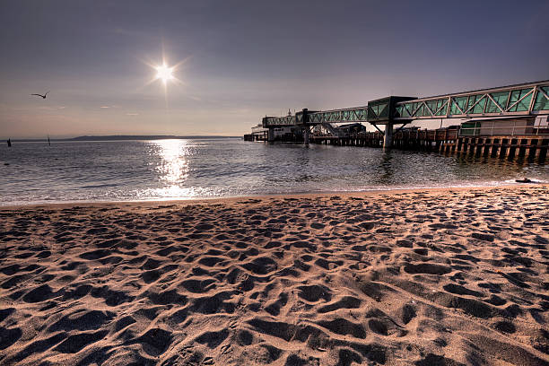 Pier, Ferry, and Beach An old pier goes to the water on the beach of edmonds washington with the ferry in the background. edmonds stock pictures, royalty-free photos & images