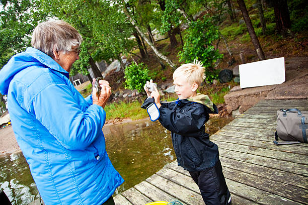 petit garçon prenant une photo prise - sweden fishing child little boys photos et images de collection