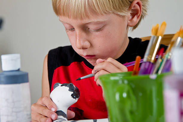 istock Caucasian Blond Little Boy Painting Pottery 182914243