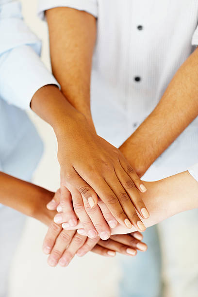 istock Several people's hands on top of each other creating a pile 182914620