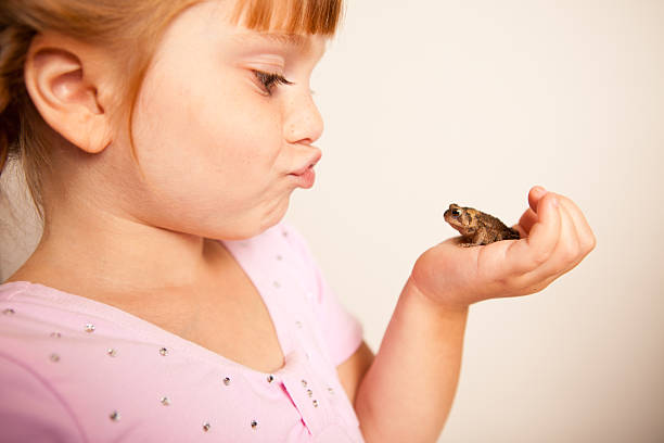 istock Little Princess Girl Puckering at a Toad 182914727